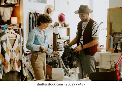 Two people engaged in sorting clothes in a vintage clothing store surrounded by various clothing items and accessories creating a well-organized setting