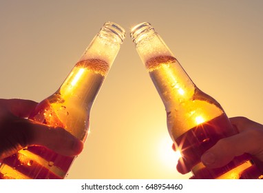 Two people enjoying a cold beer on a hot summer day.  - Powered by Shutterstock