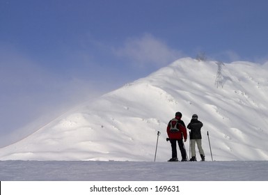 Two People In Front Of A Mountaintop