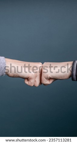 two people greeting each other with knuckles