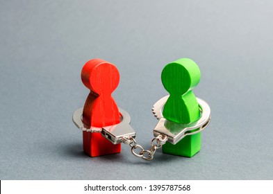 Two People Are Handcuffed To Each Other. Unclosed Obligations Between Two Persons, Financial Or Moral Debt. Contract, Duty, Responsibility And Duty. Keep The Word, Keep The Promise.