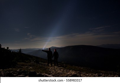 Two People Are Hiking At The Night