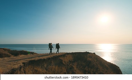 The two people hiking on the seascape background - Powered by Shutterstock