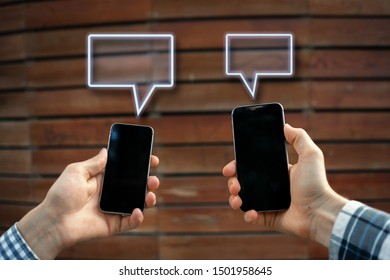 two people holding smartphones and chatting with each other. global communication concept  - Shutterstock ID 1501958645