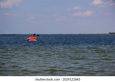 Two people in a kayak are sailing on the lake - Powered by Shutterstock