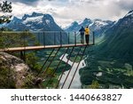 Two people are looking down from the observation deck rampestreken. Norway. Andalsnes