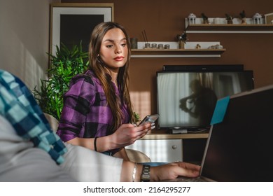 Two People Man And Woman Young Adult Caucasian Couple Boyfriend And Girlfriend Or Married Husband And Wife Sitting On The Sofa Bed At Home Real People Copy Space Estranged Family Time Bored Copy Space