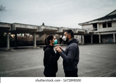 Two People In Masks Holding Hands.Couple Being Divided By Incurable Infectious Disease.Infection Control,isolation.Loved One Illness.Saying Goodbye.Farewell.Letting Go.Toxic Relationship.