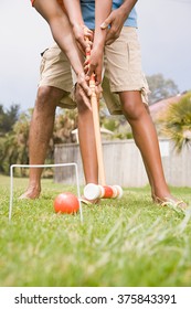 Two People Playing Croquet