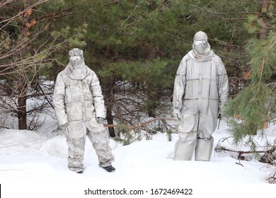 Two People In Protective Suits And Glasses In Nature