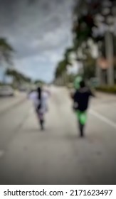 two people riding a motorcycle again lifting tires on asphalt road seen from the background blur abstract background