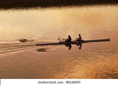 two people rowing on a river - Powered by Shutterstock