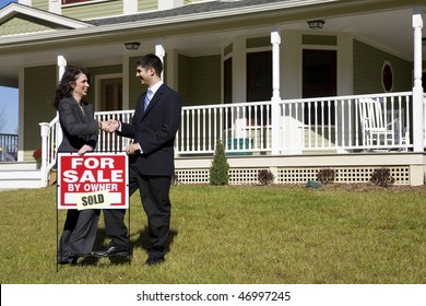 Two People Shake Hands As They Place A 