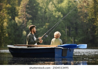 Two people sitting in boat surrounded by lush forest and calm water holding fishing rods on relaxing day fishing on peaceful lake creating bonding moment - Powered by Shutterstock