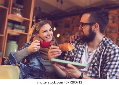 Two people sitting in a cafe, having breakfast and enjoying a time spent with each other