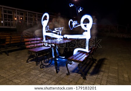 two people sitting on the bench are drawn with freeze light