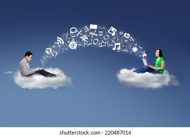 Two people sitting on cloud using laptop to share information