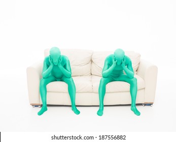 Two People Sitting On The Couch, Thinking, Hands On Head