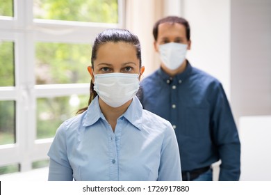 Two People Standing In Line Wearing Face Masks