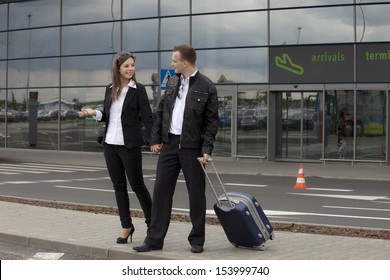 Two People With Suitcase At The Airport Parking