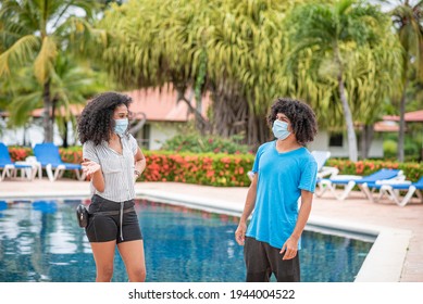 Two People In Swimming Pool Greeting Each Other With Covid19 Mask