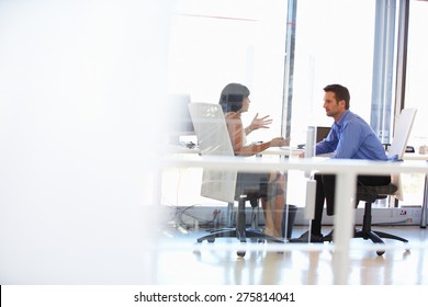 Two people talking in an office