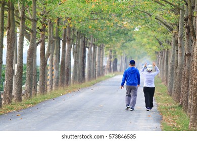 two people walking in the street