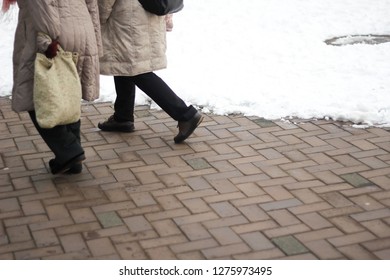 Two people walking on walk street on winter season, copy space background. - Shutterstock ID 1275973495