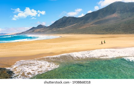 Two People Walks In Cofete Beach,  Fuerteventura, Canary Islands, Spain