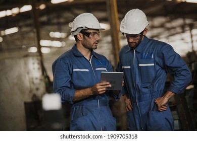 Two People Working. Male Industrial Engineers Talk With Factory Worker While Using Tablet. 