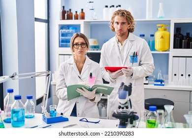 Two People Working At Scientist Laboratory Depressed And Worry For Distress, Crying Angry And Afraid. Sad Expression. 