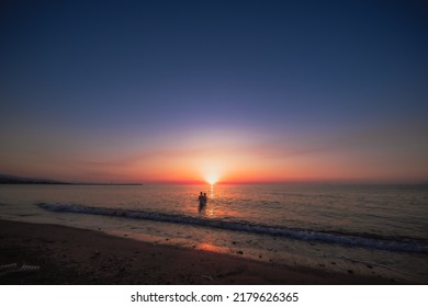 Two Peoples In Water Sea At The Sunset In My Favourite Place