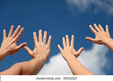 Two persons lifting their hands up in the air.