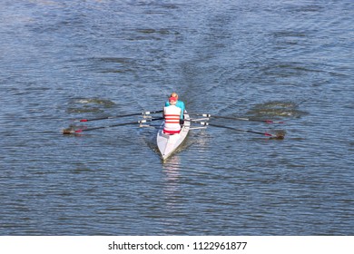 Two persons rowing boat on Arno River, Florence, Italy. - Powered by Shutterstock