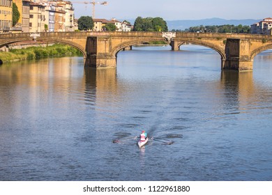 Two persons rowing boat on Arno River, Florence, Italy. - Powered by Shutterstock