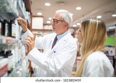 Two Pharmacists Checking Their Inventory In Their Pharmacy