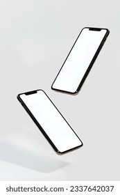 Two phones floating above the ground on white background