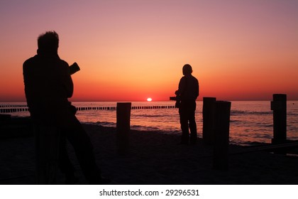 Two Photographers Waiting For The Right Moment