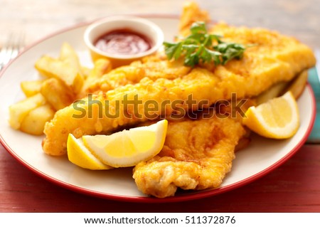 Two pieces of battered fish on a plate with chips