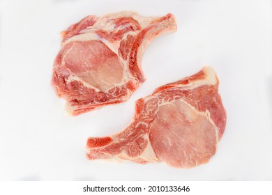 Two Pieces Of Raw Pork Chops Bone In Isolated On White Background. Top View.