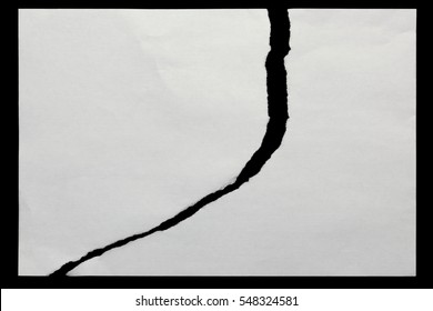 Two Pieces Of Torn Paper On A Black Background