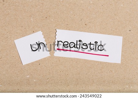 Two pieces of white paper with the word unrealistic turned into realistic