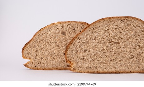 Two Pieces Of Whole Grain Bread On The White Background