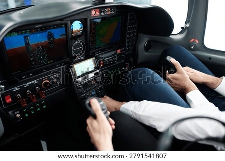 Two pilots operating flight controls in a modern general aviation aircraft cockpit, learning to fly with advanced instruments