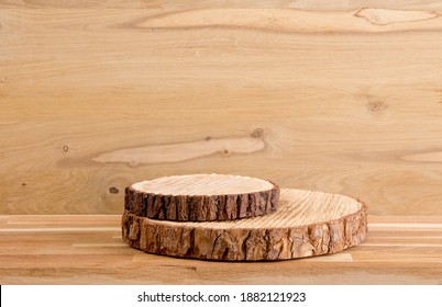Two pine tree wood discs stacked as a podium for products, natural wood board background with lot of copy space, studio shot.