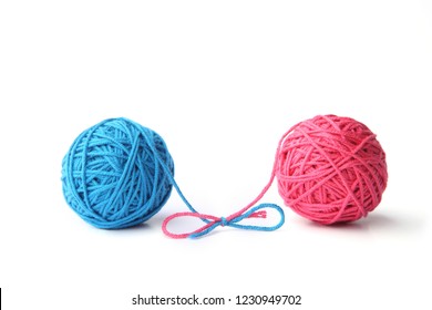 Two Pink And Blue Cotton Thread Balls Tied In Bow Isolated On White Background.  Different Color Pink And Blue Thread Balls. 
