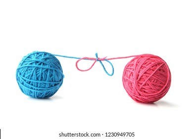 Two Pink And Blue Cotton Thread Balls Tied In Bow Isolated On White Background.  Different Color Pink And Blue Thread Balls. 
