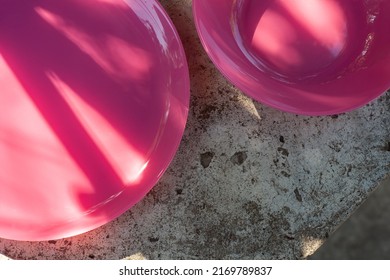 Two Pink Plates On A Concrete Tabletop. Table Setting. Dinner