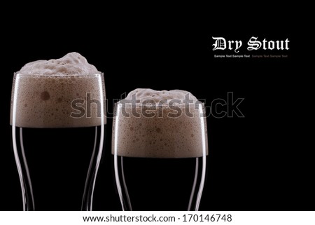 Two Pints of Dark Beer on a Black Background. Copy Space 