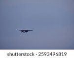 Two Piper PA-18 Super Cub airplanes fly in tandem just after take off in winter